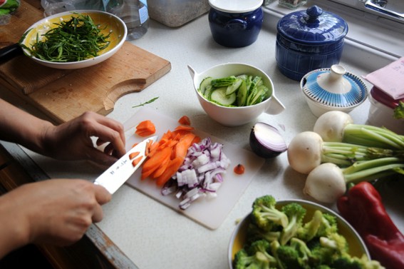 Two hands chopping vegetables