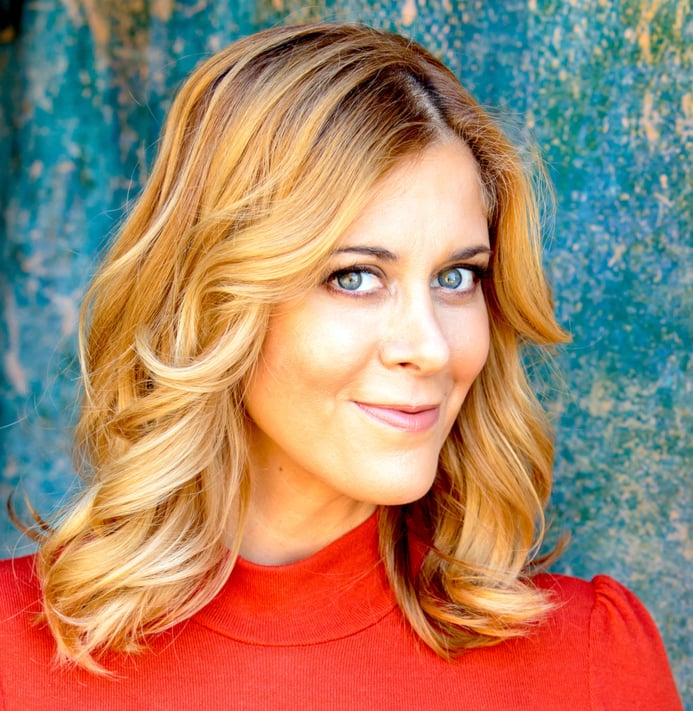 A headshot photo of Annie Wood in red shirt