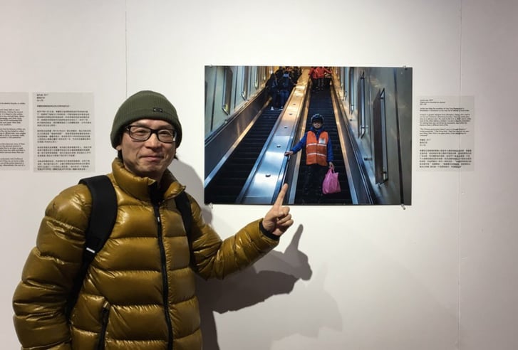 Jackie Lee visiting the exhibition and posing with a photograph taken of him