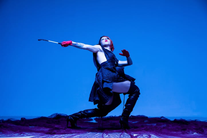 Agatha Wright, Founder of Fluxus Haus, dances against blue background