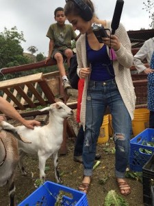 Woman standing next to a goat