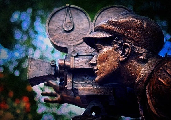 A sculpture of a man and a camera.