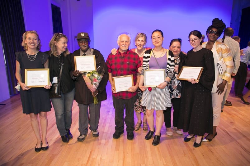 Community honorees hold their awards at FAB NYC’s “LES Community Hero Awards”