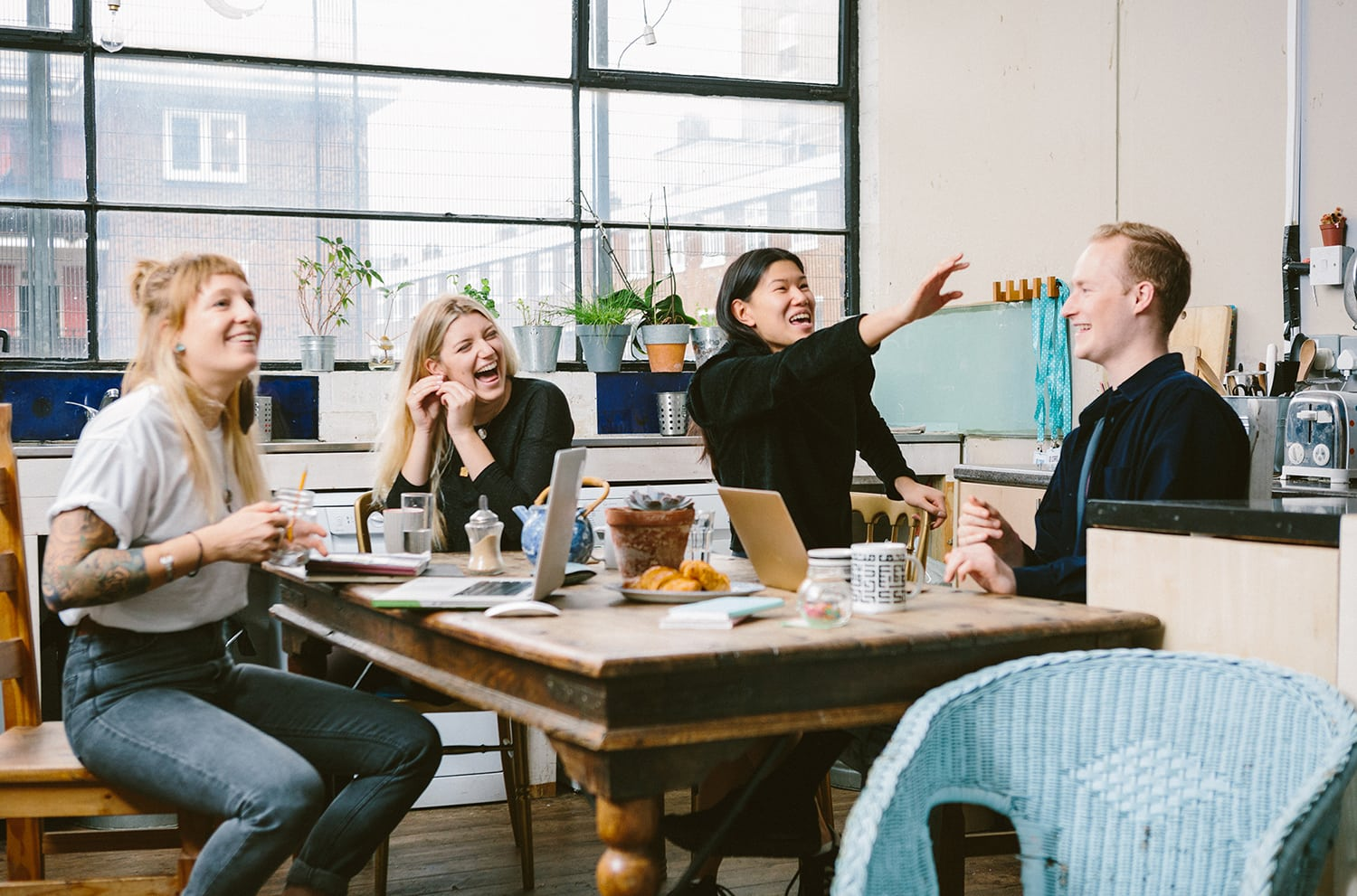 Group of colleagues laughing and collaborating