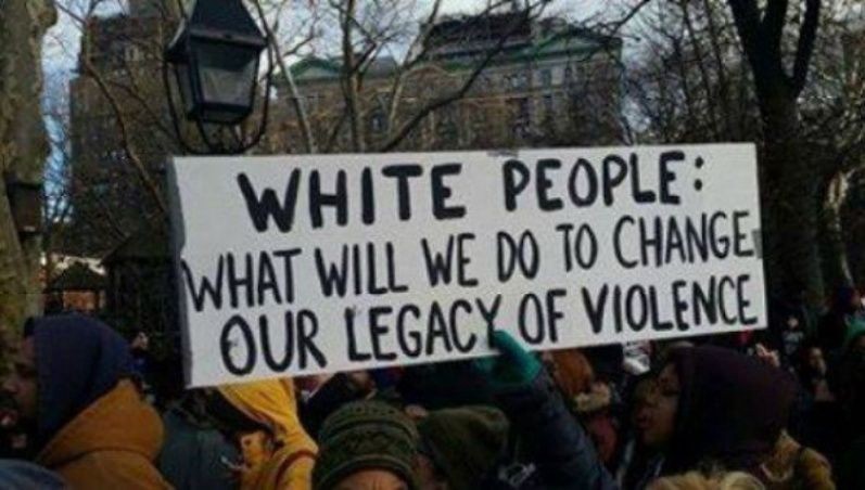 Protest sign that reads "White People: what will we do to change our legacy of violence"