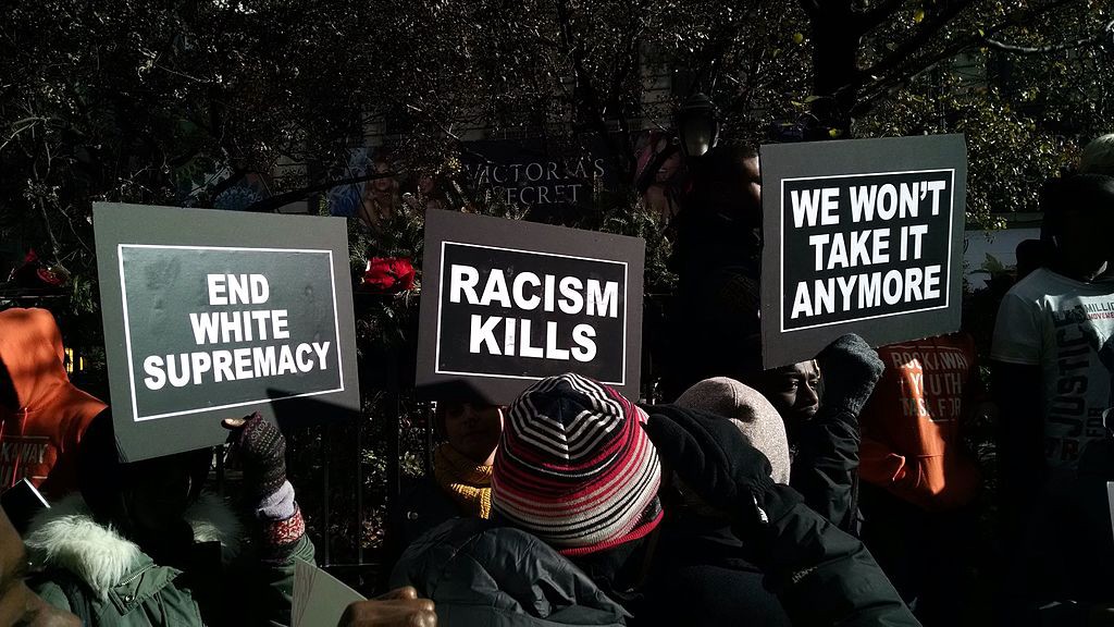 Three protest signs that read, "End White Supremacy;" "Racism Kills" and "We Won't Take it Anymore."